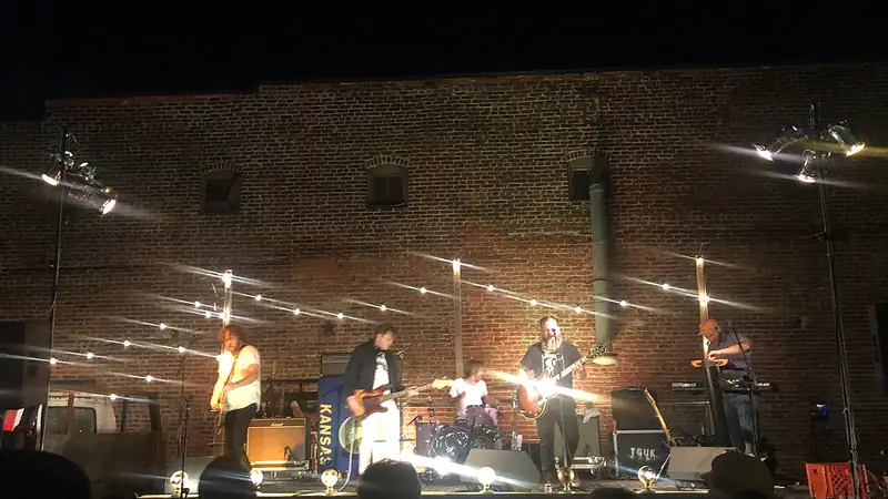 A band playing on the stage at Lemonade Park after dark