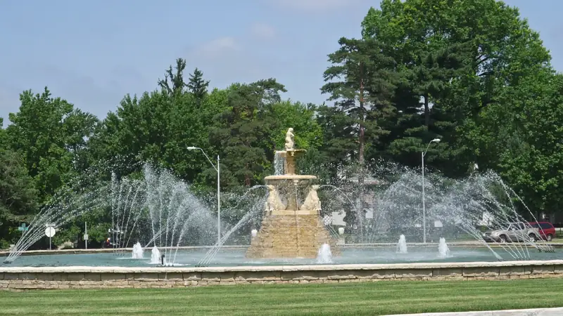 The Meyer Circle Sea Horse Fountain spraying water across its round pool, with trees all around