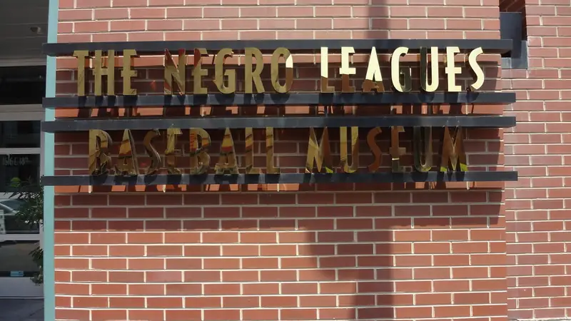 The Negro Leagues Baseball Museum's name in metal letters on its brick wall at 18th and Vine