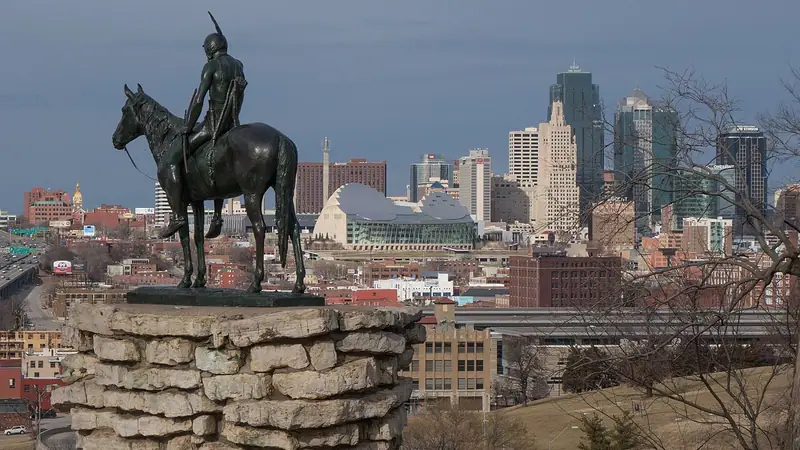 The Scout statue at Penn Valley Park with the downtown skyline behind it