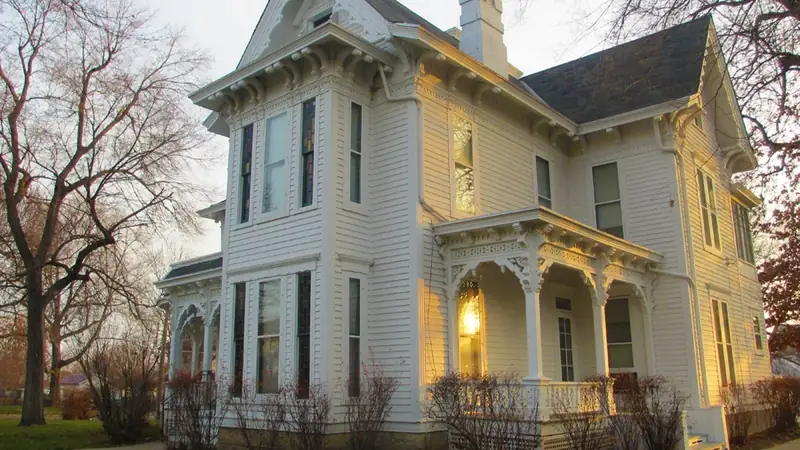 The white Victorian Truman Home on North Delaware Street in Independence, lit by late afternoon sun